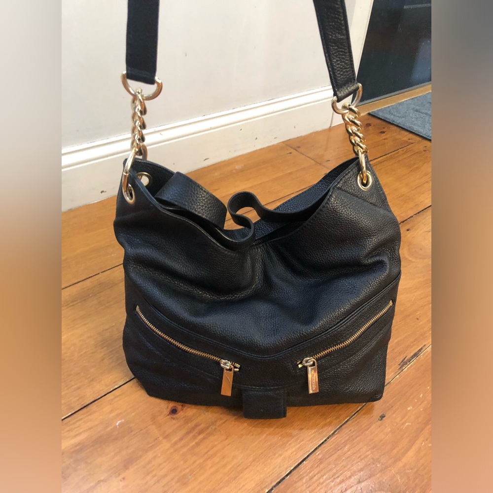 Michael Kors pebbled leather purse with gold chain and leather strap.